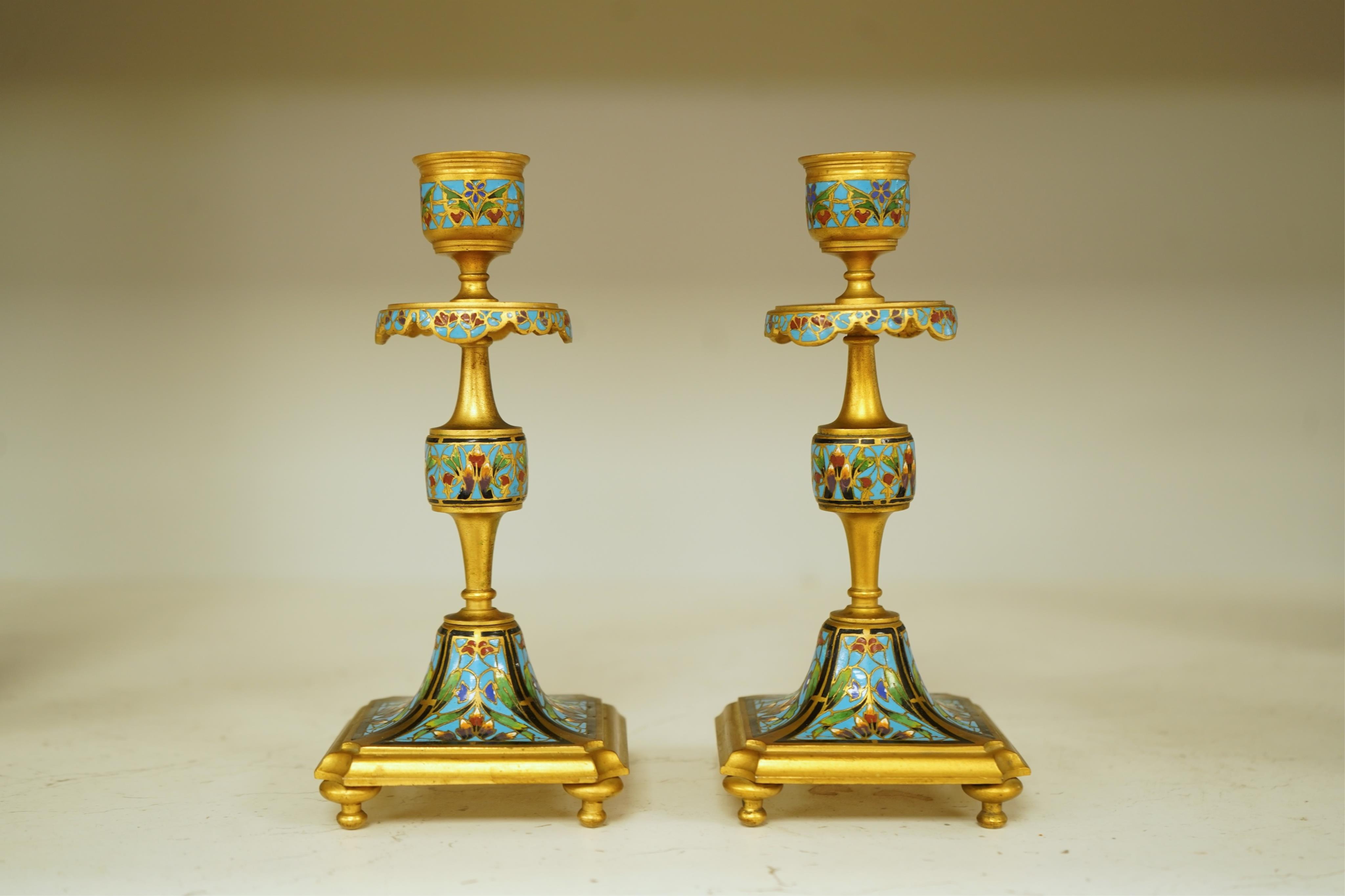 A pair of late 19th century French champleve enamel and ormolu candlesticks, 17cm